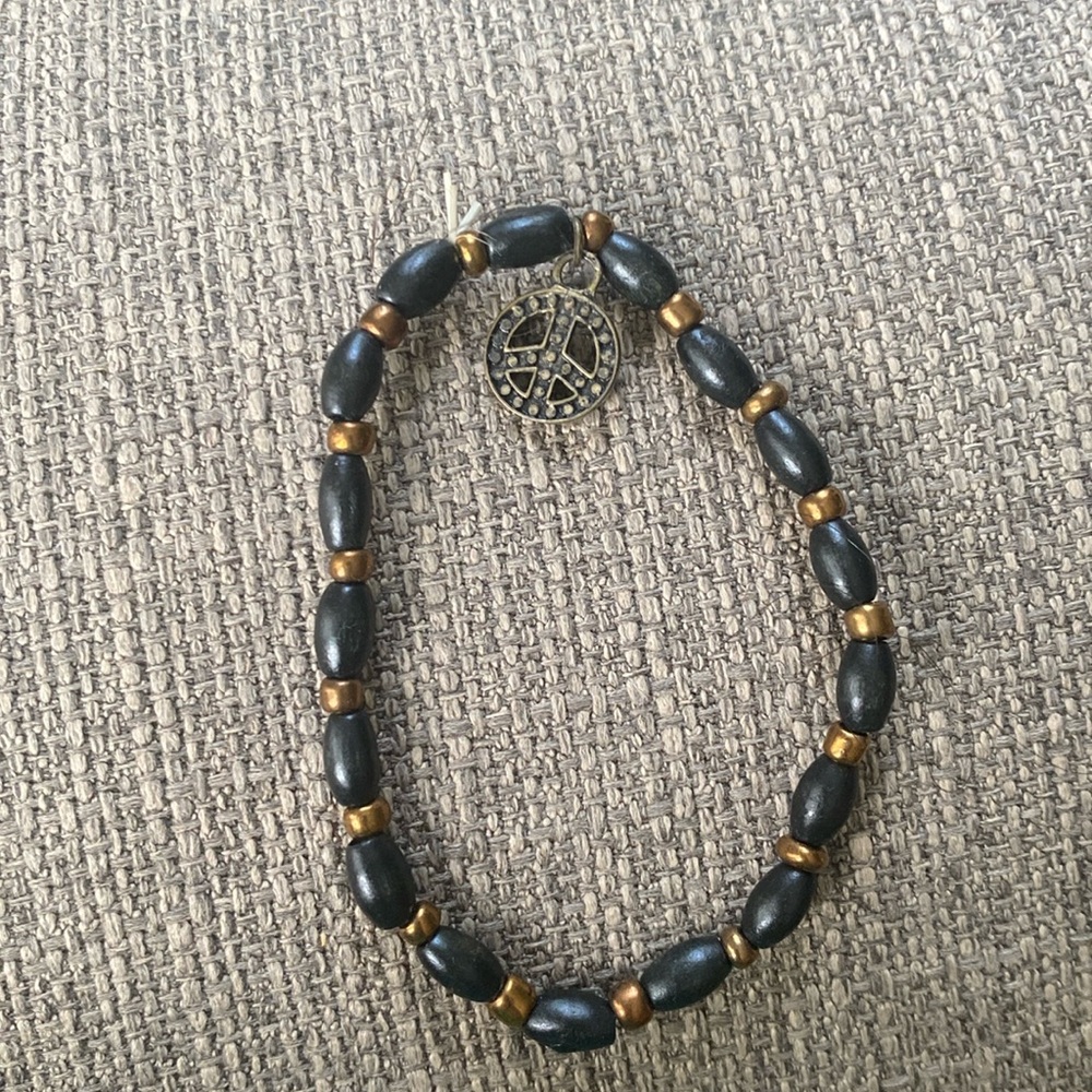 Black bracelet with peace sign charm